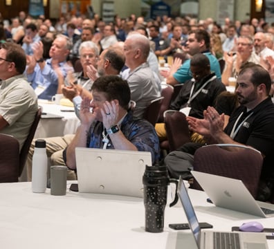 Conference session attendees taking notes during a session