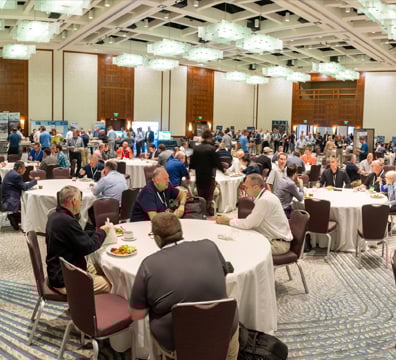 Full conference session room of roundtables
