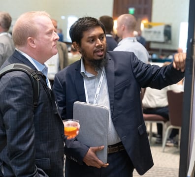 Attendees discussing GWMS Poster Presentation