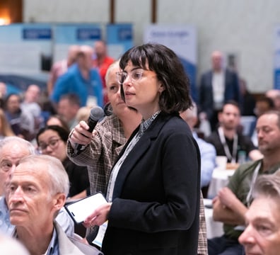 Attendee asking a question during a presentation