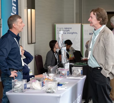 Attendee having a discussion with a tabletop sponsor